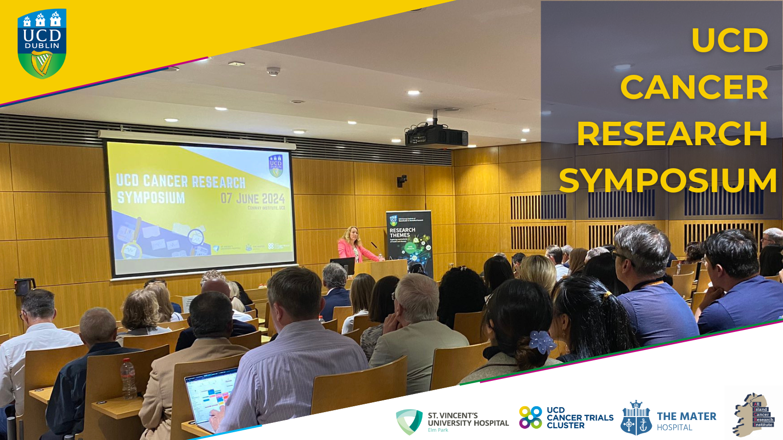 Image of people attending the UCD Cancer Research Symposium at the UCD Conway on 7th June 2024. The logos of UCD, the UCD Cancer Trials Cluster, St Vinctent's and the Mater Hospital are present. The text 'UCD Cancer Trials Cluster' is overlayed on the image.